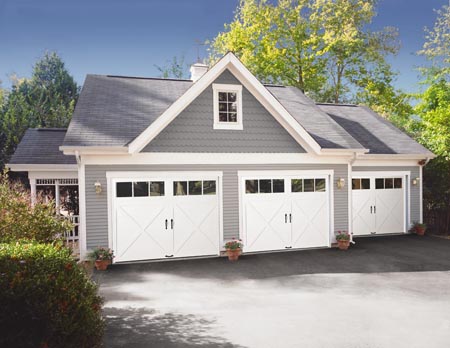 Residential home with white Clopay carriage house style garage doors